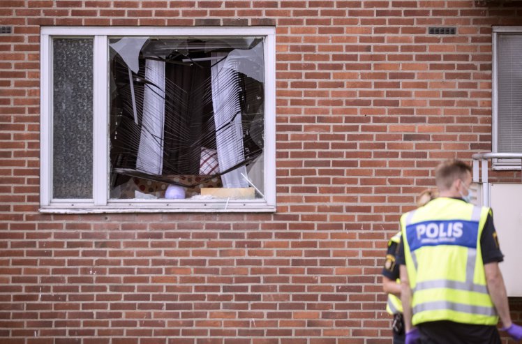 Police forensic officers investigate the area after an explosion at an apartment block, in Biskopsgarden, Goteborg, south of Sweden, Monday, Aug. 22, 2016. Swedish police say that an 8-year-old boy was killed in a hand grenade attack at an apartment in the southwestern city of Goteborg early Monday. (Bjorn Larsson Rosvall/TT News Agency via AP)